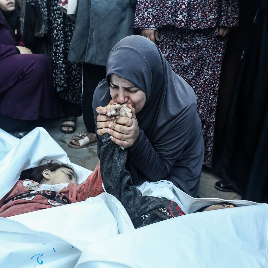 the-mother-of-eight-year-old-twins-ahmed-and-jihan-nasser,-who-were-killed-during-israeli-bombardment,-kisses-their-hand…
